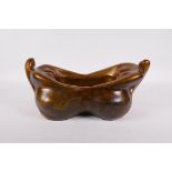 A bronze bowl modelled in the form of two plump ladies, 14" x 8"