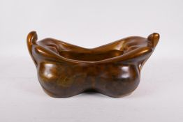 A bronze bowl modelled in the form of two plump ladies, 14" x 8"