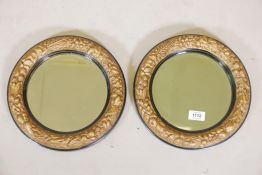 A pair of C19th ebonised wood and gilt painted composition wall mirrors, inset with bevelled