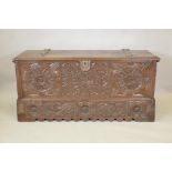 An antique French walnut chest, of plank construction, and fine carved decoration of sunbursts and