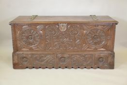 An antique French walnut chest, of plank construction, and fine carved decoration of sunbursts and