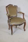 A late C18th/early C19th French walnut show frame open armchair with carved and shaped back raised