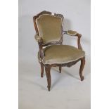 A late C18th/early C19th French walnut show frame open armchair with carved and shaped back raised