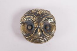 A brass vesta in the form of an owl head, 1½" diameter