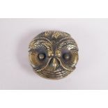 A brass vesta in the form of an owl head, 1½" diameter