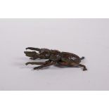 A Japanese Jizai style bronze beetle, impressed seal mark to base, 2" long