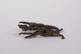 A Japanese Jizai style bronze beetle, impressed seal mark to base, 2" long