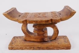 An African carved wood ceremonial stool, 7" high