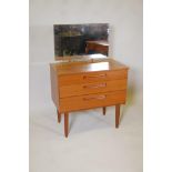 A mid century teak veneered dressing table of small proportions with three long drawers, 29" x