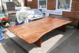 A bespoke mahogany plank top table raised on a plank end base, 12ft x 6ft