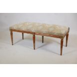 A stained and polished beechwood window seat with parcel gilt decoration, 47" x 20" x 18"