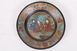 A lacquered papier mache plate, decorated with Japanese figures, 7" diameter