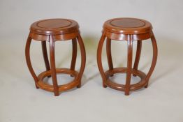 A pair of Chinese hardwood pierced barrel shaped stands/stools, 13" diameter, 18" high