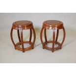 A pair of Chinese hardwood pierced barrel shaped stands/stools, 13" diameter, 18" high