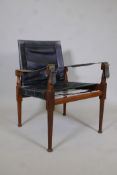 A mid century teak and black leather safari chair, 32" high