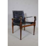 A mid century teak and black leather safari chair, 32" high