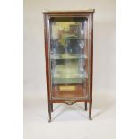 A French Empire style rosewood vitrine, with marble top and pierced brass gallery, single door