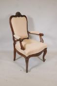 A C91th French walnut open arm chair, the shaped back with carved crest, scroll arms and shaped