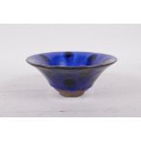 A Chinese Jian kiln pottery bowl with a blue spot glaze