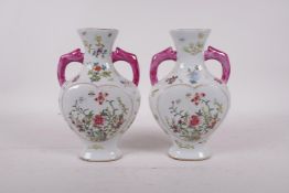 A pair of famille rose porcelain heart shaped vases with two handles and blossom decoration,