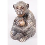 A well modelled plaster figure of two monkeys, 10" high