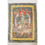A Tibetan tanka depicting a green deity, 31" x 42"