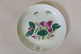 A Chinese Republic period ceramic dish with raised enamel decoration of a lotus flower, seal mark to