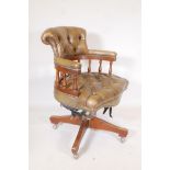 A tilt and swivel desk chair with button back leather cover and brass stud decoration, A/F spindle