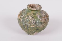 An antique green glazed terracotta pot with raised dragon decoration, A/F, 2" high