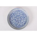 A Chinese blue and white porcelain dish decorated with a scrolling floral pattern, 7" diameter