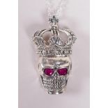 A sterling silver pendant necklace in the form of a skull wearing a crown, 1½" drop