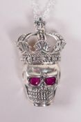 A sterling silver pendant necklace in the form of a skull wearing a crown, 1½" drop