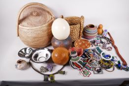 A collection of African artefacts including an ostrich egg, pottery bowls, gourds, bead jewellery