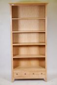 A blonde oak open shelf bookcase, with four shelves and draw to base, supplied by John Lewis, 73"