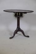 A Georgian style tilt top table with bird cage movement, the pie crust top on a fluted column and