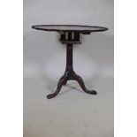 A Georgian style tilt top table with bird cage movement, the pie crust top on a fluted column and