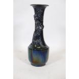 An Oriental famille noir ceramic vase with lustre glaze and raised decoration of a dragon, 21" high