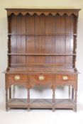 A C19th oak dresser, the delft rack with dummy drawers on a base of three drawers over an open pot