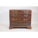 A Georgian mahogany caddy top chest with four graduated long drawers, each with scratch moulded