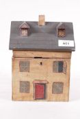 A wood box in the form of a cottage with naive painted decoration, 6" x 6" x 8"
