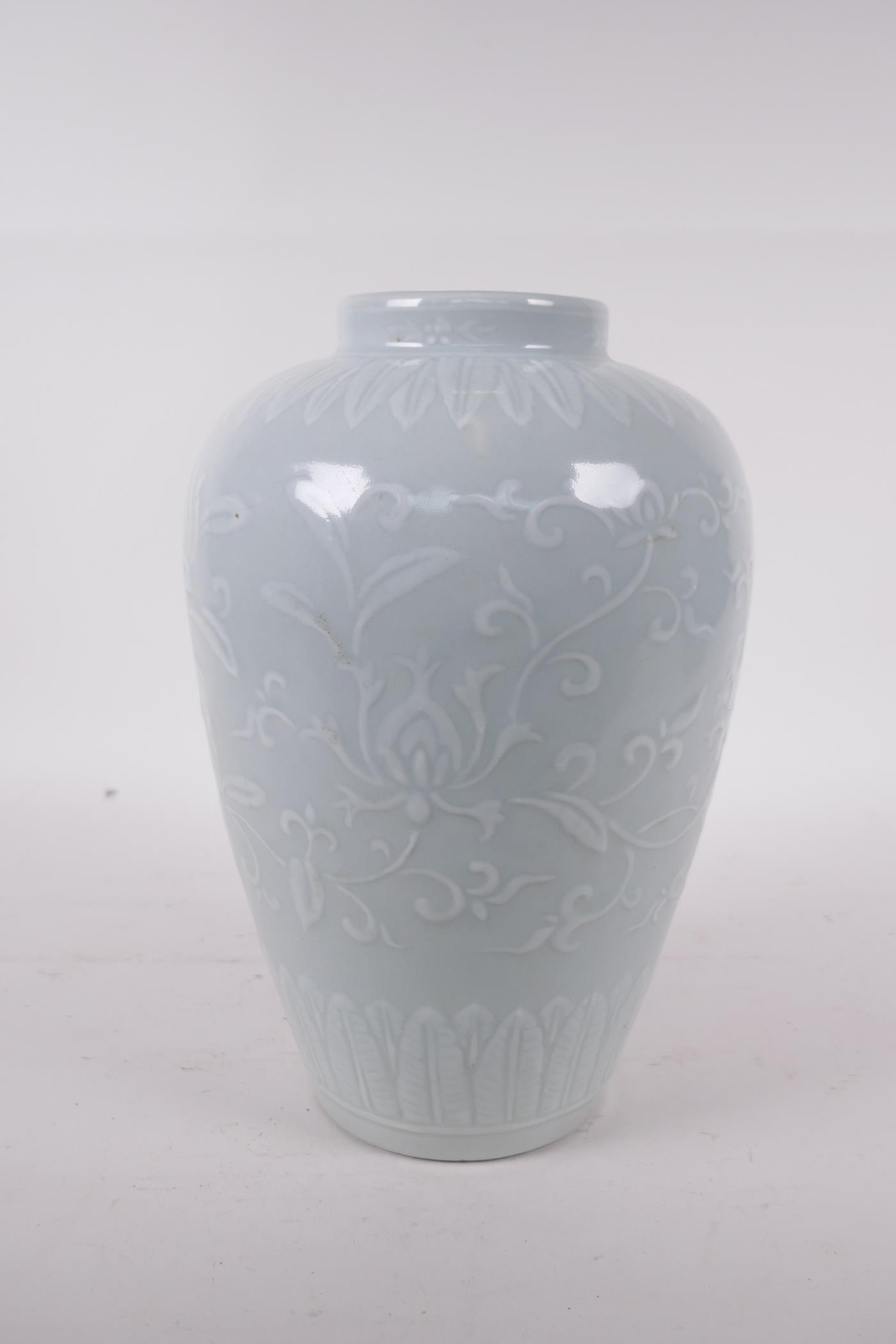 A celadon glazed porcelain jar with raised underglaze lotus flower decoration, incised six character - Image 4 of 5