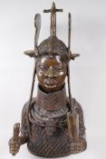 A Benin bronze bust of a figure in elaborate headdress and mail jacket, 22" high