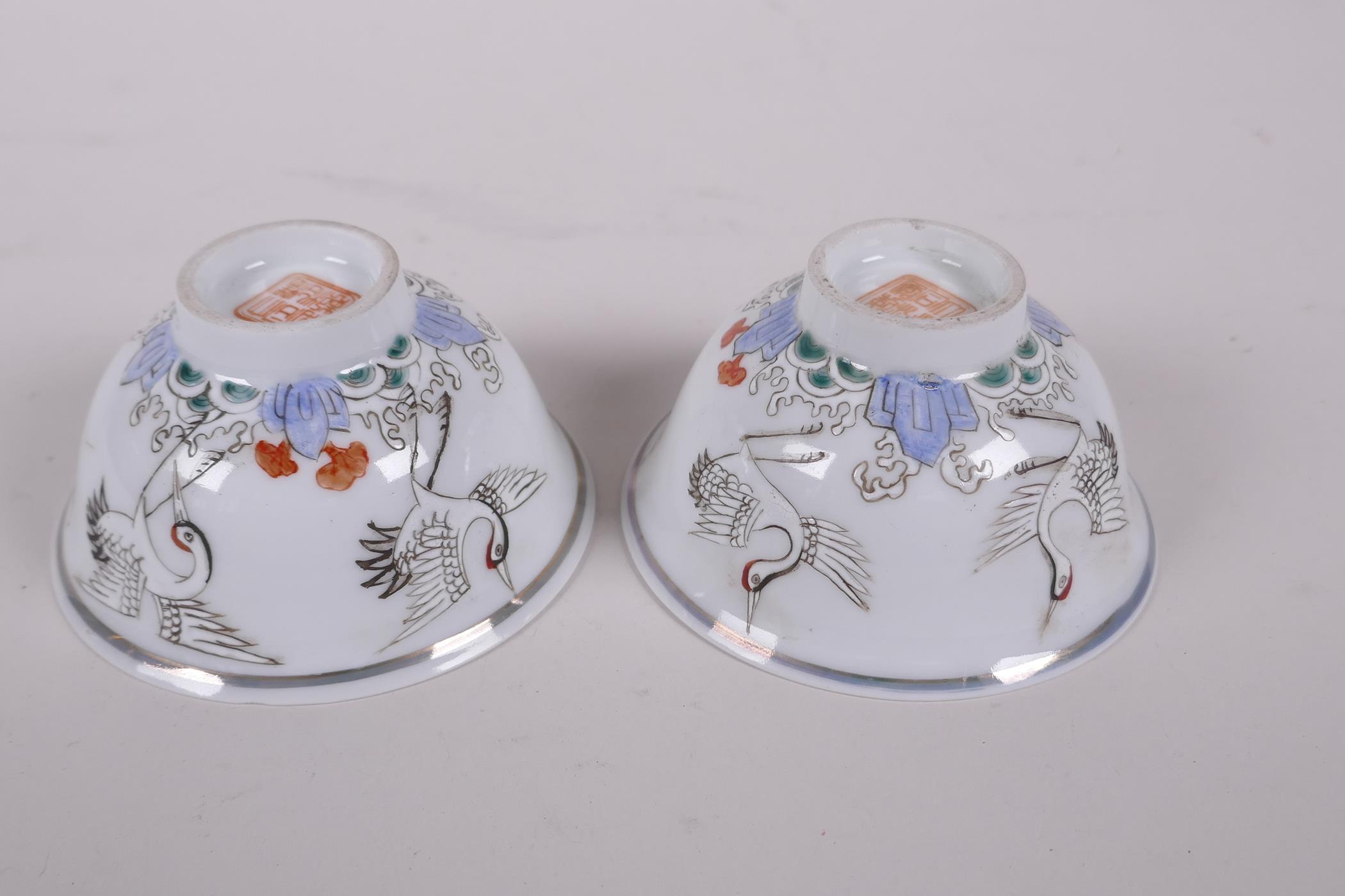 A pair of early C20th Chinese polychrome porcelain tea bowls decorated with cranes, seal mark to - Image 3 of 6