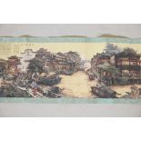 A Chinese printed scroll depicting a town scene, with character inscription panels to either end,