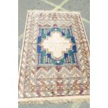 An Oriental style carpet decorated with geometric designs within multiple borders, 78" x 55"
