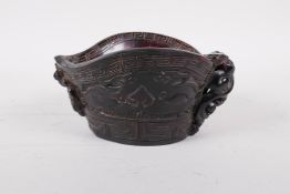 A Chinese faux horn libation cup with carved kylin decoration, mark to base, 3" high