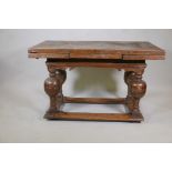 An antique Dutch oak drawleaf table, the plank top with two pull out leaves, raised on a shaped