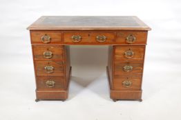A Victorian walnut pedestal desk with an inset faux leather top and nine drawers, 40" x 23", 27"