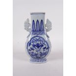 A Chinese blue and white porcelain vase with two handles, decorated with waterfowl in a lotus