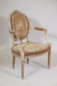 A C19th painted French elbow chair with carved details, fluted legs and embroidered seat and back,